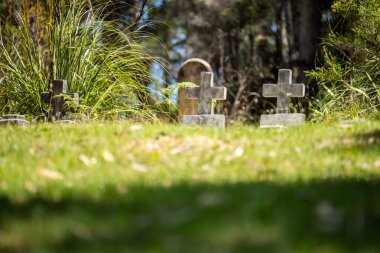cemetery graves and cross in a graveyard in a church