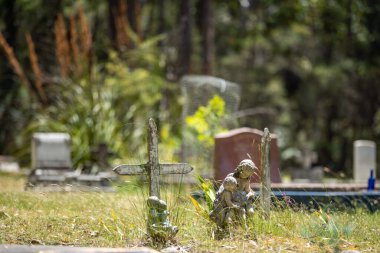 cemetery graves and cross in a graveyard in a church