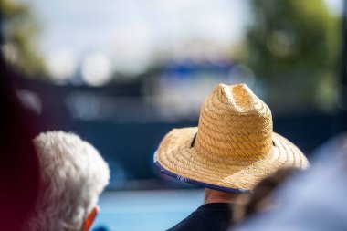 tennis fan watching a tennis match at the australian open eating food and drinking