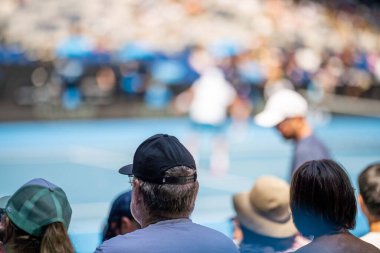 fans watching a sporting match and sporting event in a stadium