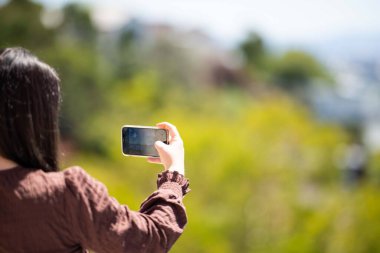Girl taking a selfie on holiday in australia. Business Woman taking a phone photo of herself on a trip im australia