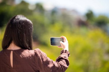 Girl taking a selfie on holiday in australia. Business Woman taking a phone photo of herself on a trip im australia