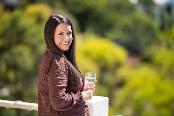 beautiful lady on a balcony having a drink in hobart australia im summer