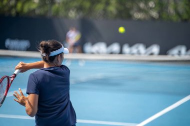 Amateur playing tennis at a tournament and match on grass in Melbourne, Australia in summer