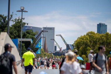 tennis fan watching a tennis match at the australian open eating food and drinking in australia