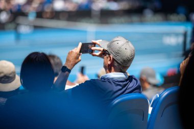 Amateur playing tennis at a tournament and match on grass in Melbourne, Australia in summer