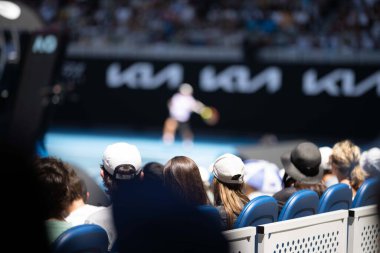 tennis fan watching a tennis match at the australian open eating food and drinking in australia