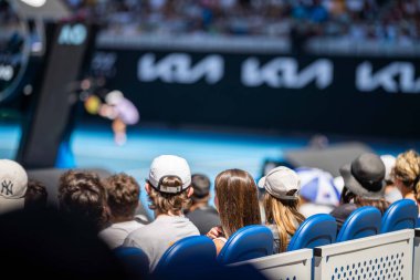 tennis fan watching a tennis match at the australian open eating food and drinking in australia