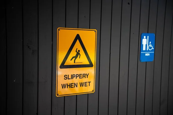 slippery floor sign on a wall
