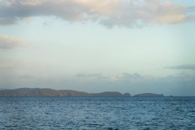 beautiful island on a blue ocean in summer at dusk 
