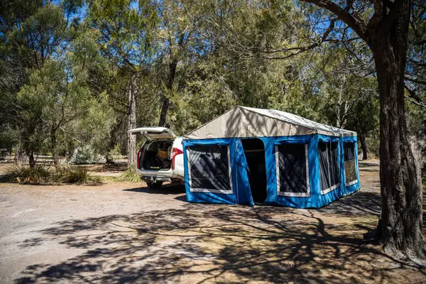 camper trailer tent set up camping in a park in the forest on a hoilday in australia in summer