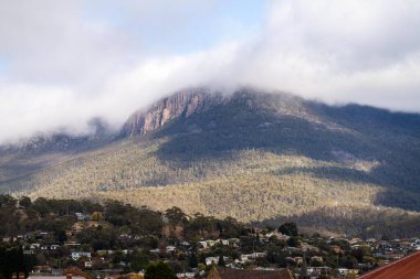 peak of a rocky mountain in a national park looking over a city below, mt wellington hobart tasmania australia  clipart