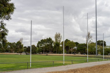 afl goal posts at a sports field in a park in australia in spring