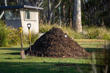 making compost pile on a farm holding microorganisms storing carbon sustainable regenerative food farm in a field on an agricultural farm  clipart