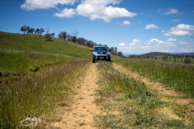 Bir çiftlikteki çim tarlasında bir kamyon. Taşrada, Avustralya 'nın taşrasında toprak bir yolda giderken bir kamyonda bir çiftlikte bir çitte.