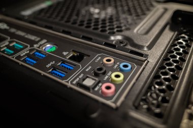 The back of the desktop computer with various inputs, USB sockets, fan