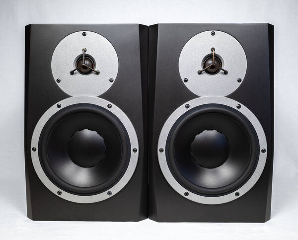 Two black audio speakers isolated on white background, musical equipment