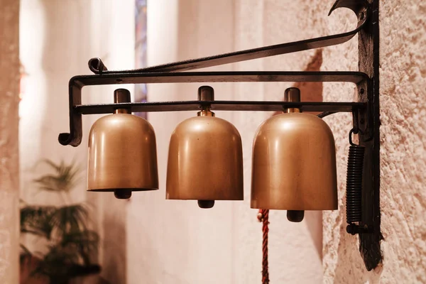 Three little bells in the church to serve at the liturgical ceremonies.