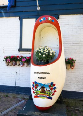 Marken, Hollanda - 26 Nisan 2022: Marken, Waterland, Hollanda 'da bir tıkanma imalatçısı önünde büyük bir dekoratif tıkanma