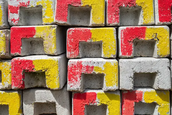 Colorful, textured brick pattern with bright yellow and red accents.