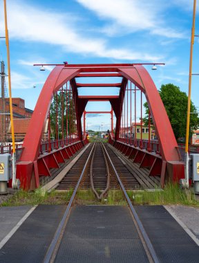 Lidkoping, İsveç - 27 Mayıs 2023: Lidkoping 'deki Lidan Nehri üzerindeki kırmızı yarı dairesel demiryolu köprüsü