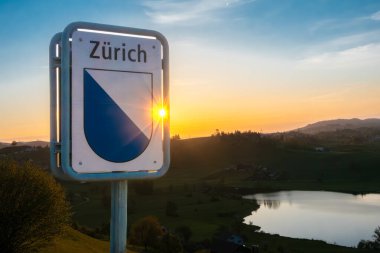 Hutten, Switzerland - April 25, 2024: Road sign at Hutten lake marking the beginning of the canton of Zurich clipart