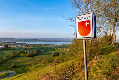 Hutten, Switzerland - April 25, 2024: Road sign in Hutten marking the beginning of the canton of Schwyz. clipart