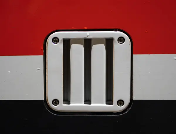 stock image Close-up of horizontal vent of the train with three slats in white frame with painted tricolor background on vehicle