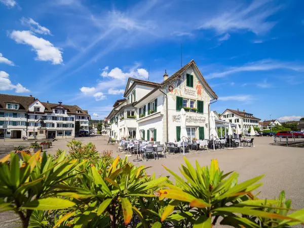 stock image Stafa, Switzerland - June 13, 2024: Charming town square of Stafa, canton Zurich, with historic restaurant Schutzenhaus.