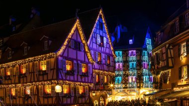 Colmar, Fransa - 27 Aralık 2023: Colmar, Alsace, Fransa 'da renkli dekorasyonlar, ışıklandırma ve aydınlatma ile Noel pazarı.