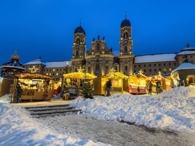 Einsiedeln, Switzerlan - December 5, 2023: Christmas market in Einsiedeln, a village in the Swiss canton of Schwyz. It is known for the Monastery, the most important baroque building in Switzerland clipart