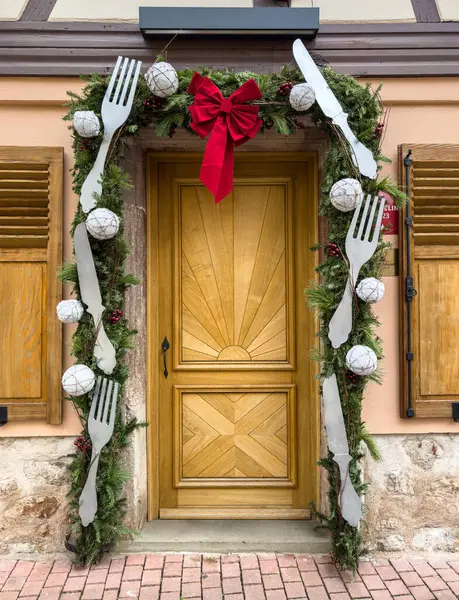 stock image Obernai, France - December 30, 2023: Christmas decoration of the front door of a restaurant in Obernai, Alsace, France