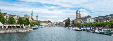 Zurich, Switzerland - July 1, 2024: Cityscape of Zurich, iconic view with river Limmat, churches, and historic buildings. clipart