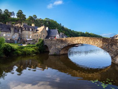 Dinan, France - July 19, 2024: Le Port de Dinan is a charming harbor with stone bridge located in the picturesque town of Dinan, Brittany, along the Rance River. Stone bridge. clipart