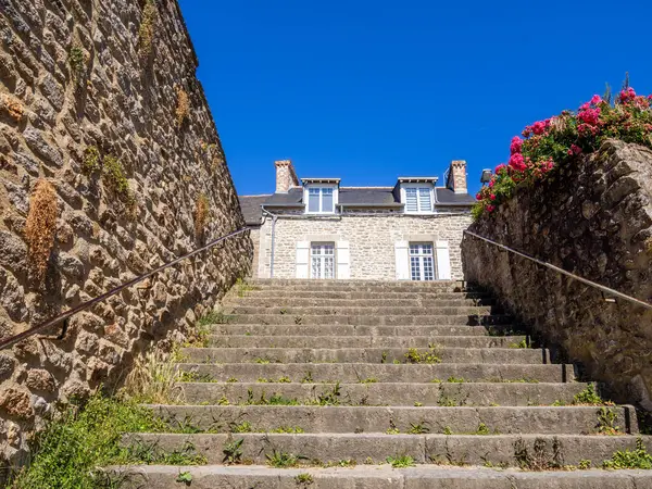 stock image Stone steps in Dinan, Brittany, leading to charming stone Breton house under sunny blue sky.