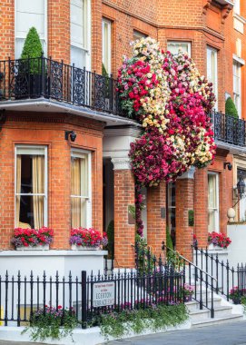 London, United Kingdom - June 25, 2024: Egerton House hotel in London with colorful garden floral installation display in honor of summer. clipart