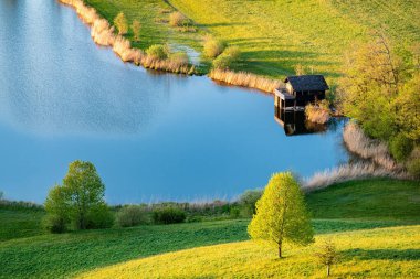 An idyllic scene in the golden hour at the Swiss lake Huttensee on the border between the cantons of Schwyz and Zurich clipart