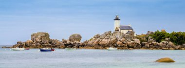 A scenic coastal panorama featuring a lighthouse of Pontusval in Brittany on a rocky shore, surrounded by calm waters and several small boats. The sky is overcast, creating a serene atmosphere. clipart