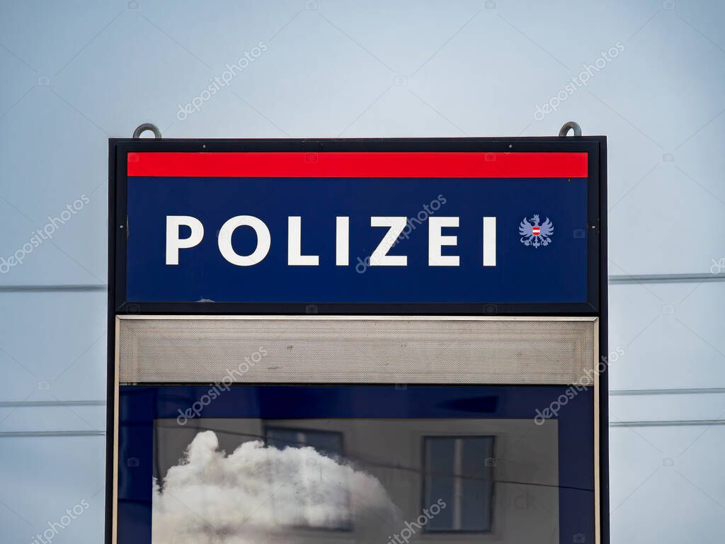 Innsbruck, Austria - March 21, 2025: Austrian police sign with POLIZEI in bold against a dark blue background.