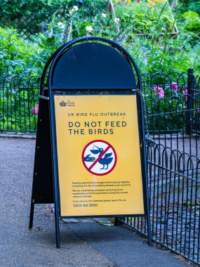 London, United Kingdom - May 26, 2025: A sign warning against feeding birds due to a bird flu outbreak in the UK.