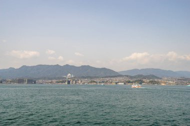 Beautiful landscape of Miyajima city with ferry boat from the island in Hiroshima prefecture, Japan.