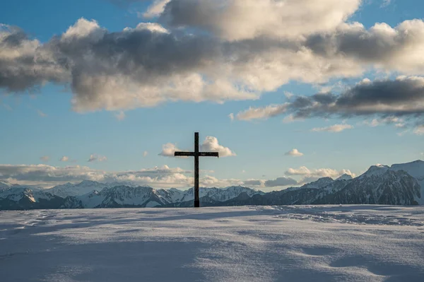 Cross in the snow. Wooden religious cross in winter. Les Pleiades, Switzerland. Tranquil scene.