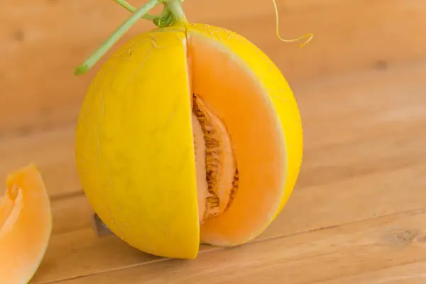 stock image split the orange melon on wood plate