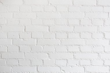 Beyaz boyalı tuğla bir duvarın fotoğrafı. Metin ve resim girmek için mükemmel