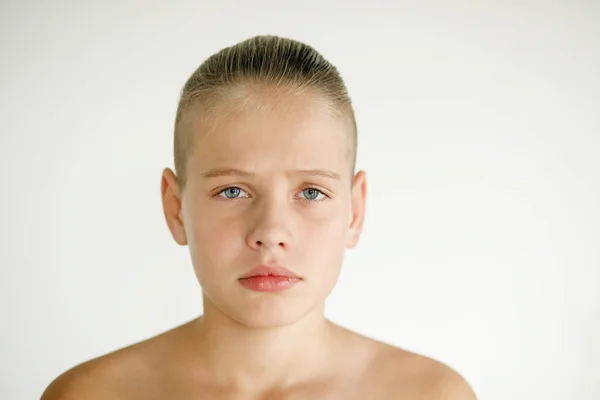 Portrait of sad teen boy on white background