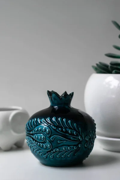 ceramic pot with a candle on a white background