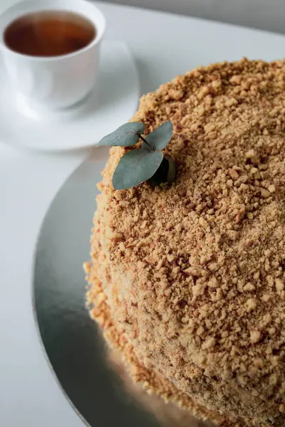 Bir dilim kek, beyaz bir tabak ve bir fincan kahve.