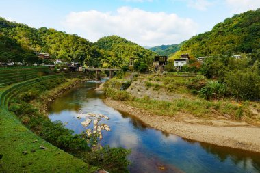 The huge river pass through the bridge and abandoned buildings