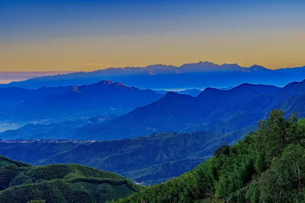 The light from the sunrise act as the background of mountains