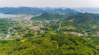 Dağınık köyleri ve deniz kenarındaki tarlaları birbirine bağlayan dolambaçlı bir yol..